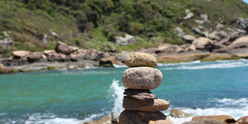 A serene natural landscape with calm water and balanced stones.
